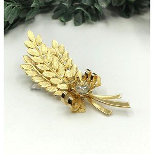 Brooch cluster of gold tone leaves and rhinestone bow by Sarah Convington
